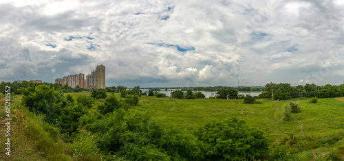 Panorama of a wasteland near the outskirts of the city of Krasnodar on the banks of the Kuban River on a summer rainy day