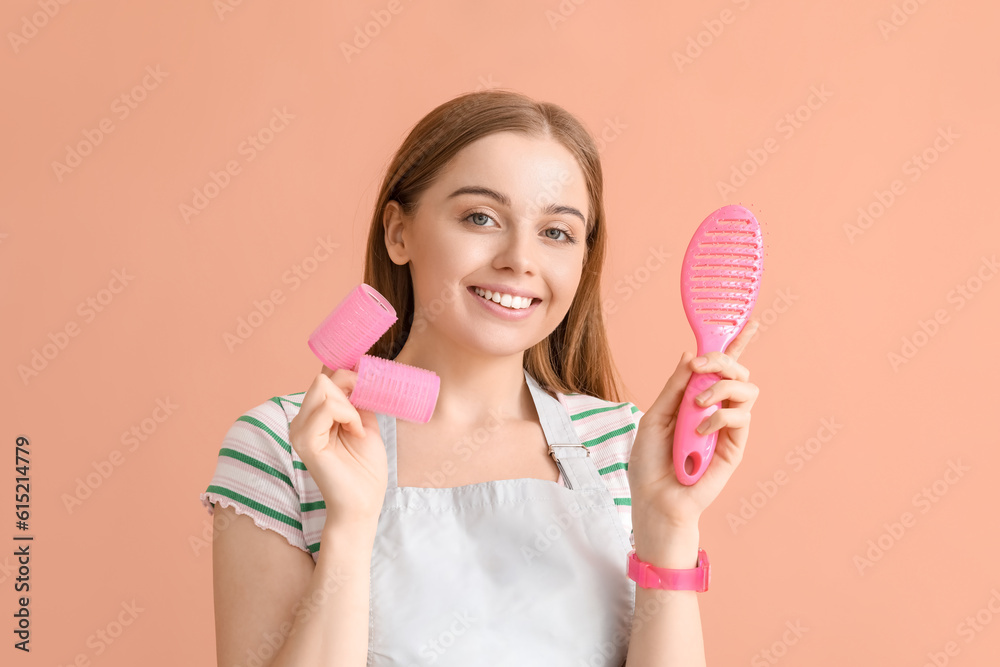 Female hairdresser with curlers and brush on pink background, closeup Female hairdresser with curlers and brush on pink background, closeup