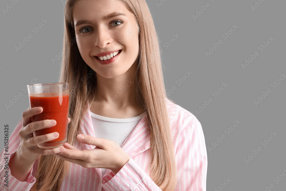 Young woman with glass of vegetable juice on grey background, closeup Young woman with glass of vegetable juice on grey background, closeup
