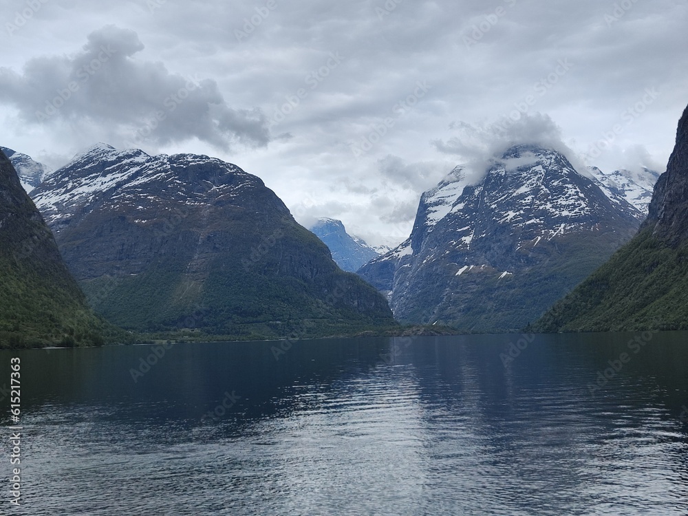 Glaciers hidden behind the mountains feed lake Lovatnet.Norway
