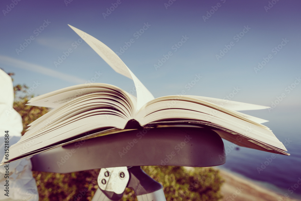 Naklejka premium Open book outdoors. Reading
