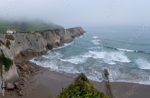 Cliffs on Itzurun beach where the Dragonstone cave is located in Zumaia, with formations called Flysch that enter the water