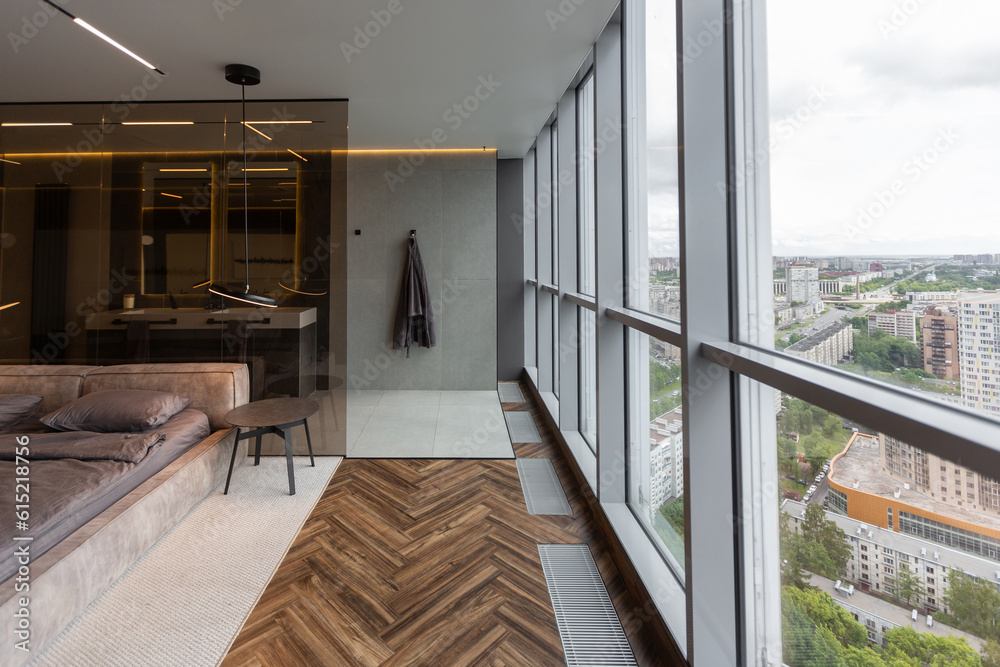 Fototapeta premium cool expensive interior design of room in prestigious luxury hotel with dark tones with modern LED lighting and stylish furniture. the area with a sink is separated by dark glass from the bedroom