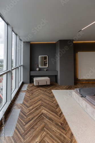 cool expensive interior design of room in prestigious luxury hotel with dark tones with modern LED lighting and stylish furniture. the area with a sink is separated by dark glass from the bedroom © 4595886