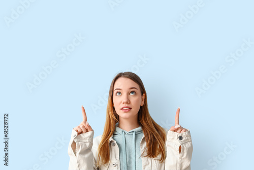 Beautiful young woman point...