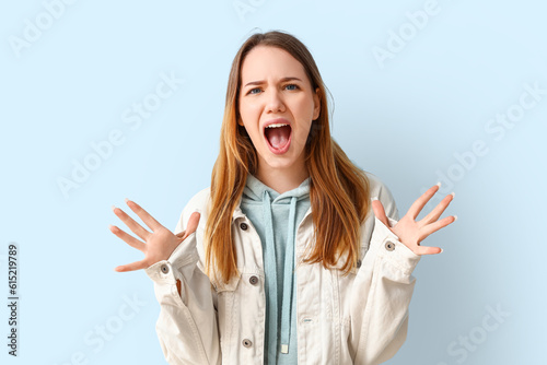 Angry young woman shouting ...
