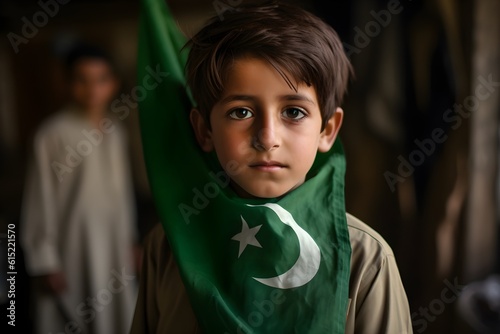 Portrait of a cute little girl holding a Pakistan flag in his hand outdoors photo