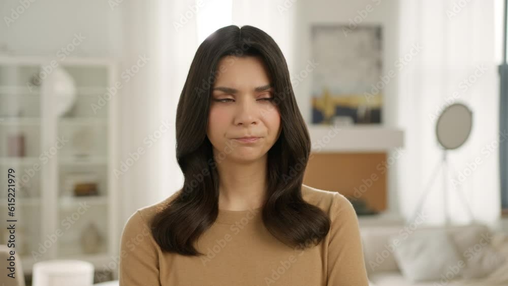 Headshot of attractive woman with serious upset face, looking at camera thinking about relationships or health problem 4K. portrait of beautiful female person standing indoors at home slow motion Headshot of attractive woman with serious upset face, looking at camera thinking about relationships or health problem 4K. portrait of beautiful female person standing indoors at home slow motion