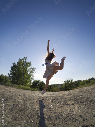 Young Dancer Jumping in a Floral Summer Dress