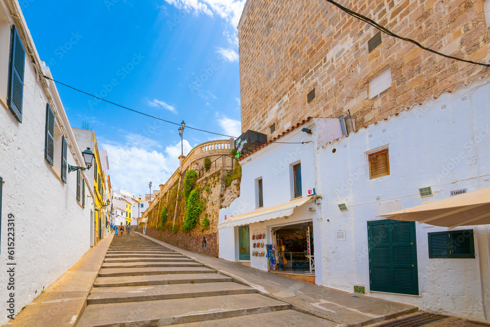 A long flight of wide steps leading to the historic medieval old town of Ciutadella de Menorca, a whitewashed fishing village on the Mediterranean on the Balearic island of Menorca, Spain.