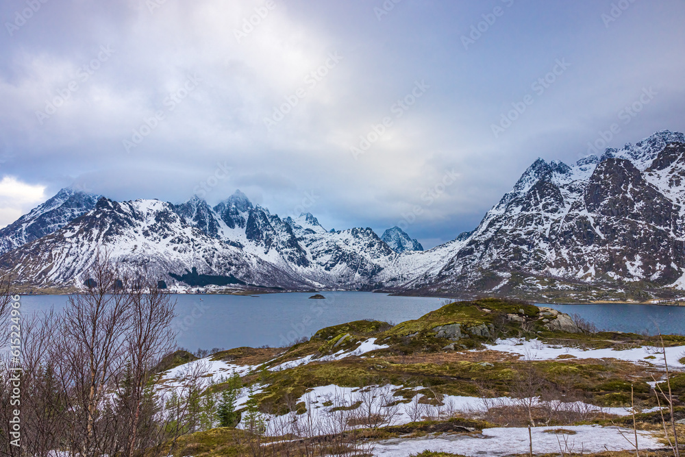 Snow capped mountains near harbor in Lofoten, Norway