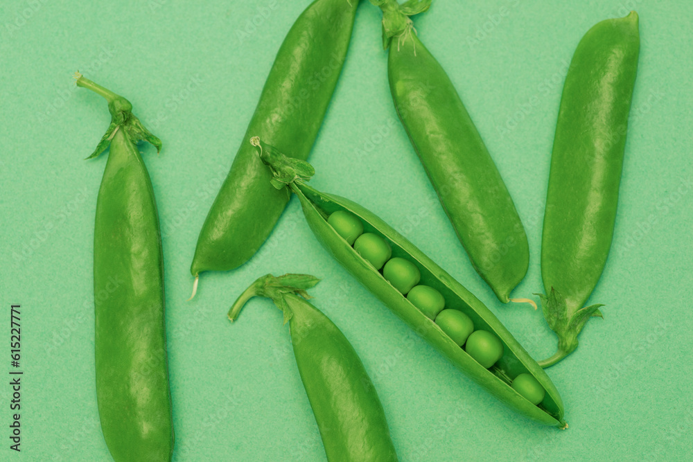 green pea pod group lies on green background green pea pod group lies on green background