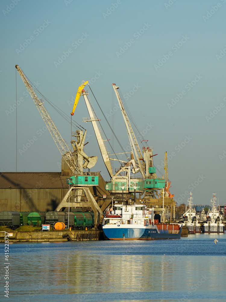 Harbor view with ships and cranes in sunset light, Liepaja, Latvia