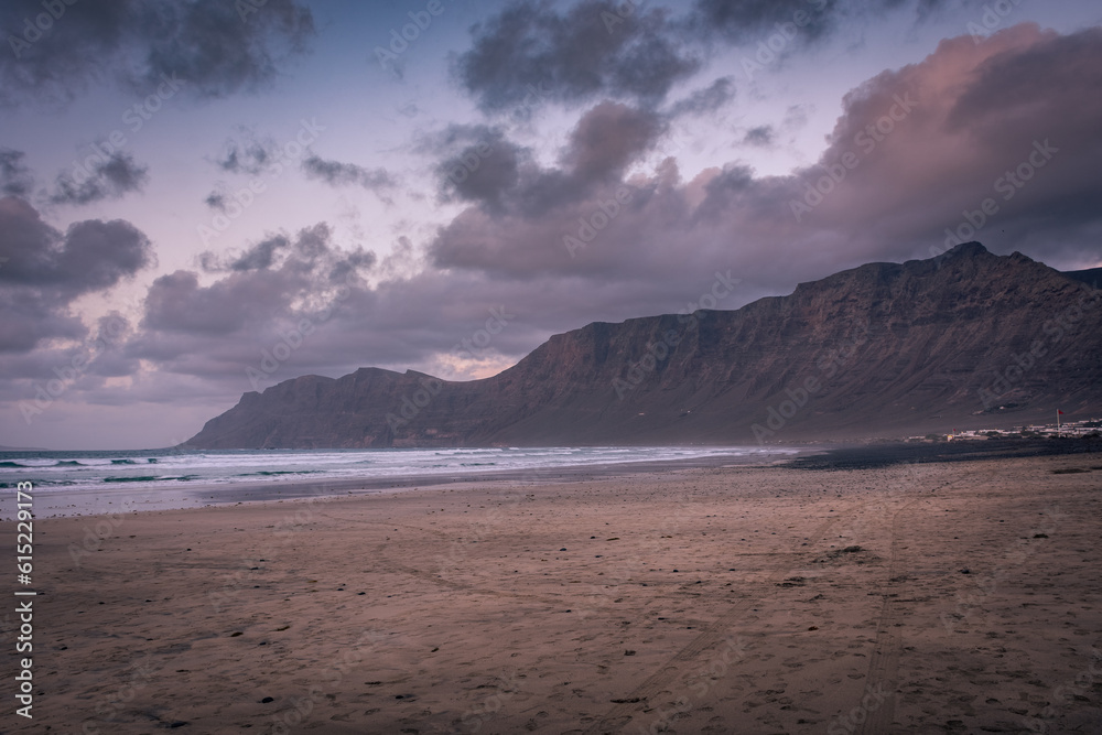 The amazing Famara beach on the Atlantic Ocean in Lanzarote, Canary Islands, Spain The amazing Famara beach on the Atlantic Ocean in Lanzarote, Canary Islands, Spain