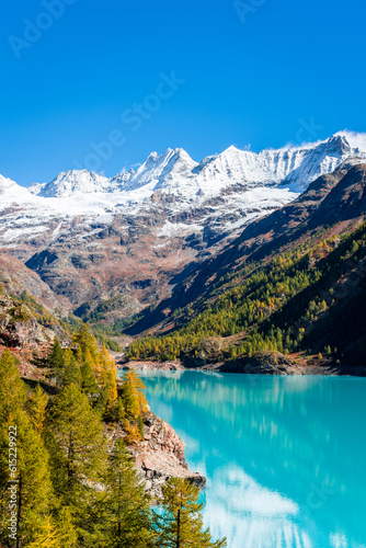 Autumnal landscape of the Lake Place Moulin, an artificial glacial lake with turquoise water in the italian Alps,  on the border with Switzerland © Stefano Zaccaria