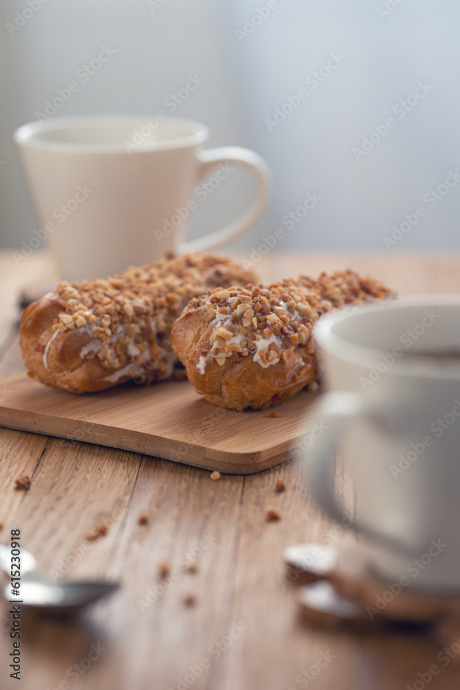 Home made cake eclairs. Traditional eclairs, profitroles classic, eclairs french. Sweet chocolate eclairs on wooden table. Home made cake eclairs. Traditional eclairs, profitroles classic, eclairs french. Sweet chocolate eclairs on wooden table.