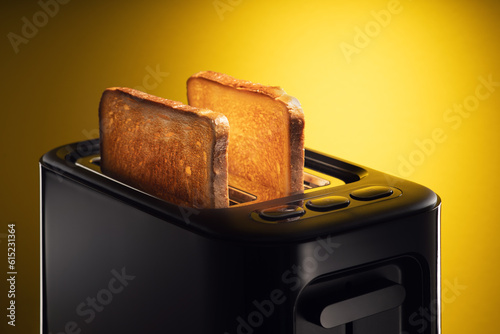 Slices of toast jumping out of the toaster against yellow background.