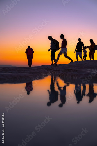 People walking by the lake at sunset, silhouette, Pamukkale - Turkey