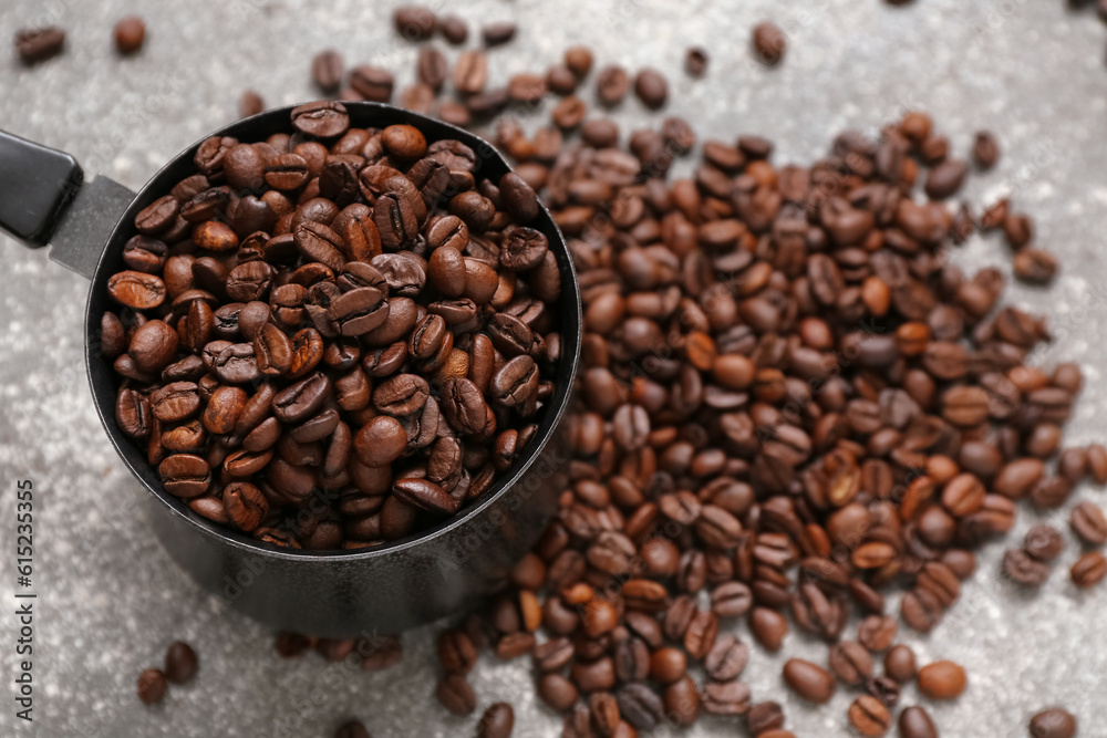 Fototapeta premium Cezve with coffee beans on grey background