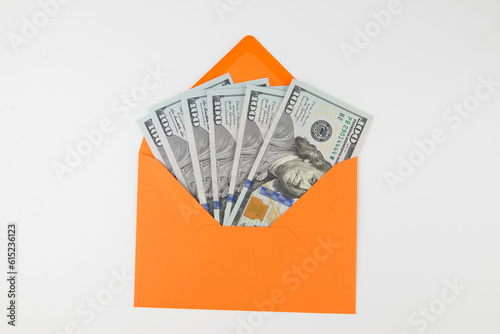 dollars in an orange envelope on white.