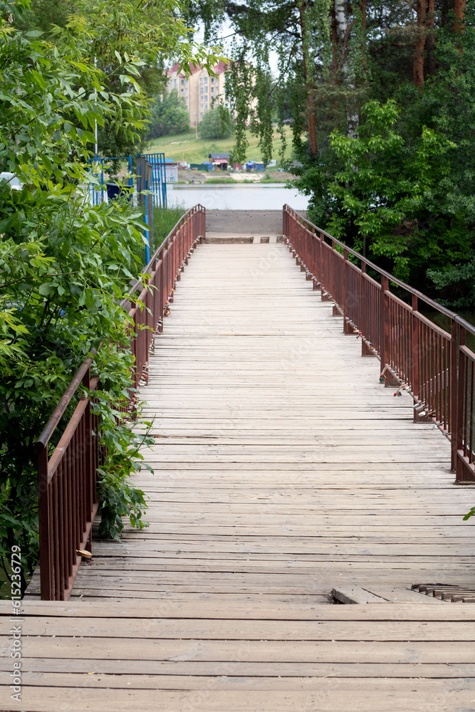 photo wooden bridge with railings over the river
