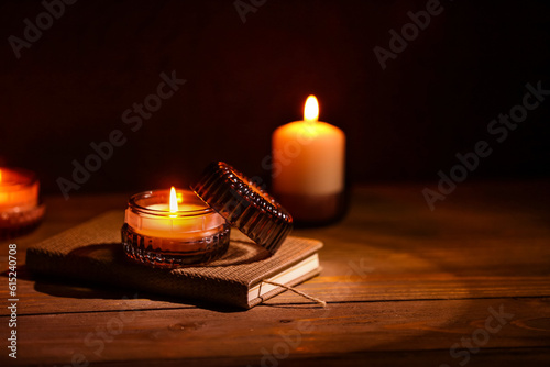 Book with burning candles o...