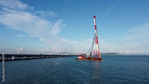Move over sea water toward marine piling work of monopole transmission tower in Malaysia photo