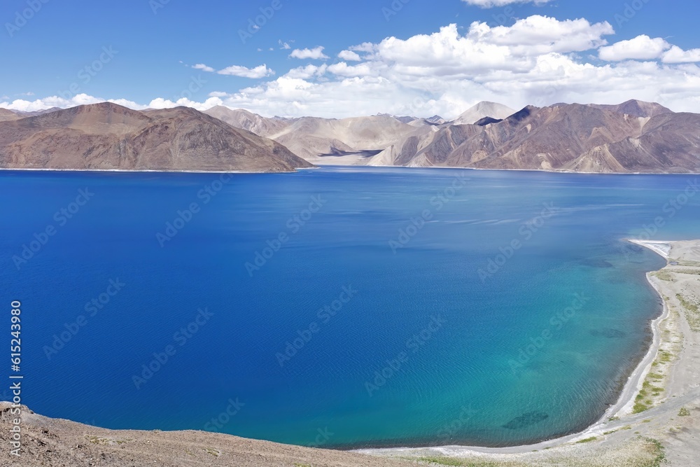 Experience the mesmerizing beauty of Pangong Tso lake in Ladakh, India, with its panoramic sapphire blue waters. 