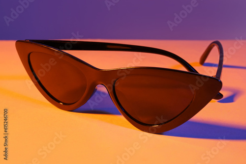 Stylish sunglasses on colorful background