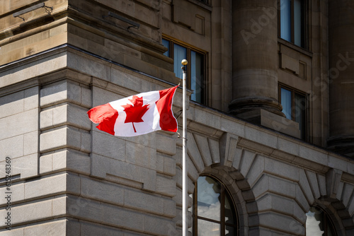 Canadian Flag Flies in front of an heritage Building in Montreal