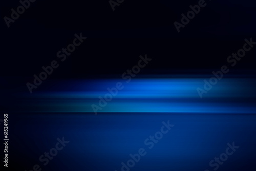 Neon blue motion light trails over black background. Abstract speed effect. Rays of light moving fast over dark background