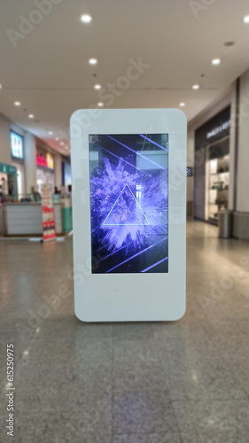 Blank advertising banner mockup in modern airport retail environment; large digital display screen. Billboard, poster, out-of-home media display space.