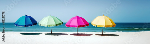 A few colorful parasols, umbrellas on a sunny beach