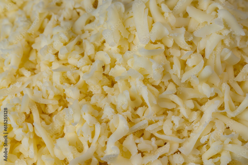 Hard cheese with holes grated into thin small slices Hard cheese with holes grated into thin small slices