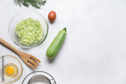 Bowl with grated zucchini a...