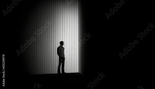 Dark empty room with the silhouette of a man standing alone. Based on Generative Ai.