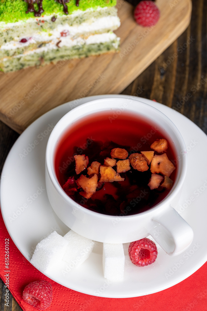 Red raspberry tea with pieces of fruit and berries Red raspberry tea with pieces of fruit and berries