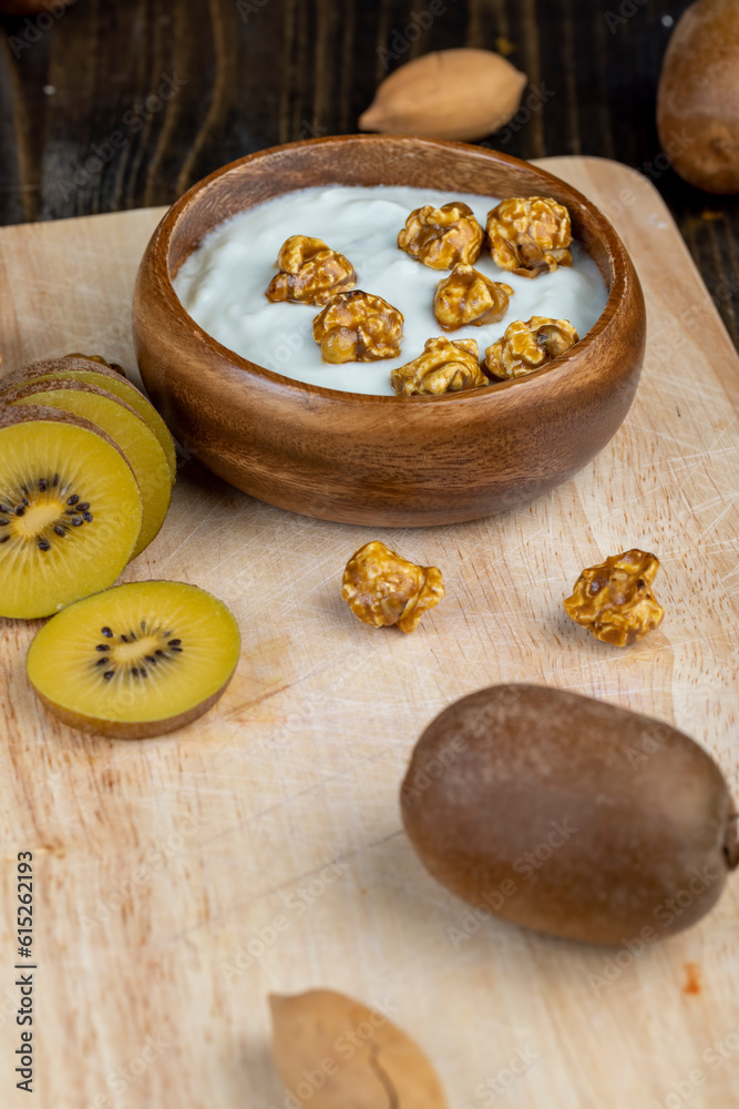 fresh yogurt with kiwi flavor and with pieces of fruit and popcorn