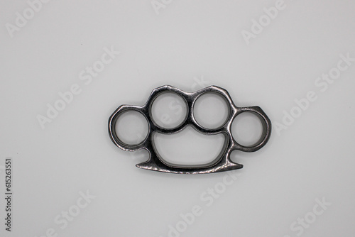 Silver Brass Knuckles Layed Down. Isolated on White Background photo