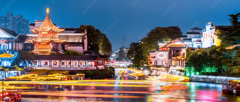 Night scenery of pleasure boats shuttling on the Qinhuai River in Nanjing, Jiangsu, China