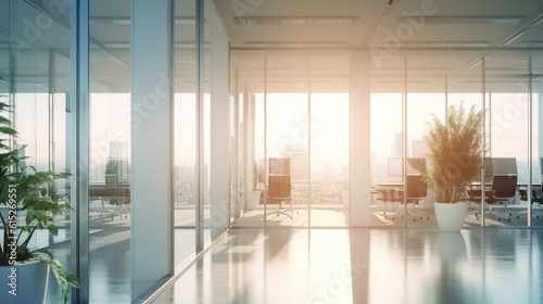 Beautiful blurred background of a light modern office interior with panoramic windows and beautiful warm lighting.