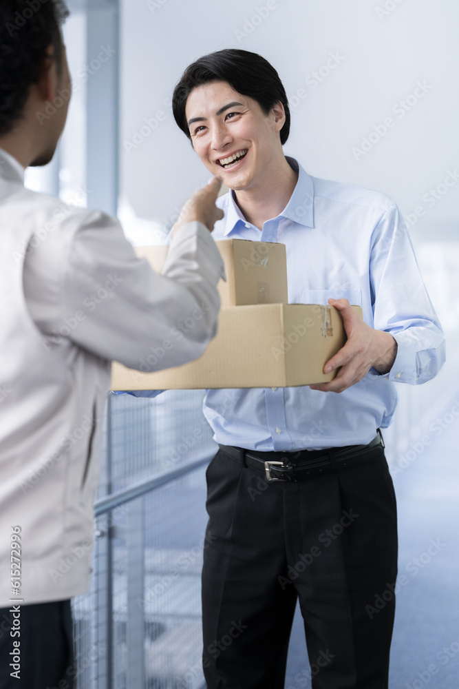 Businessman receiving cardboard boxes and packages at work, also in the image of delivery and transportation. Businessman receiving cardboard boxes and packages at work, also in the image of delivery and transportation.
