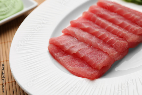 Tasty sashimi (pieces of fresh raw tuna) on white plate, closeup