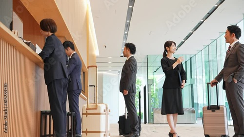 A guide in the lobby. Guests being guided at the front desk of the hotel.
