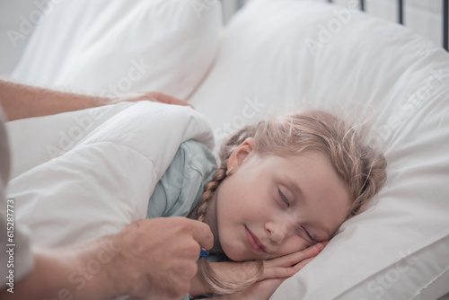 Father singing his daughter to sleep, providing comfort, support, and security. Focusing on fulfilling both physical and emotional needs. Kids sometimes act happy while pretending to fall asleep.