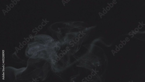 Slow motion of white smoke, fog, mist, vapor on a black background. photo