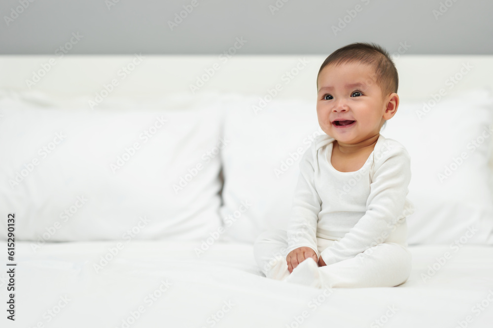 happy infant baby sitting on bed happy infant baby sitting on bed