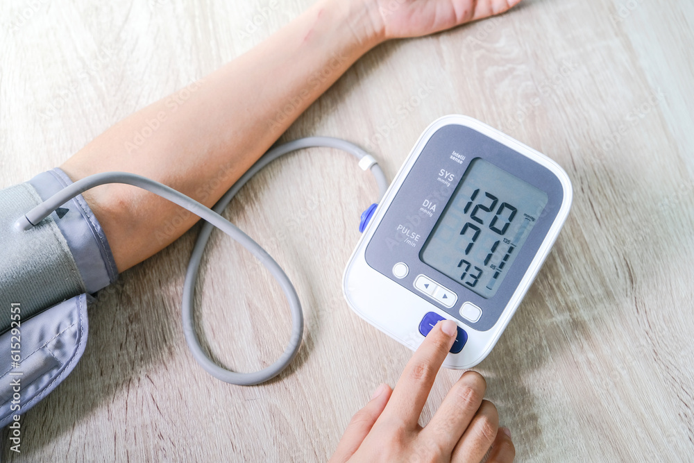 Man check blood pressure monitor and heart rate monitor with digital pressure gauge. Health care and Medical concept Man check blood pressure monitor and heart rate monitor with digital pressure gauge. Health care and Medical concept
