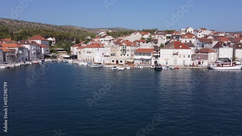 Wallpaper Mural Two-floor limestone houses along the quays of protected Harbor in Milna Town, Brac Island. Aerial dolly out Torontodigital.ca