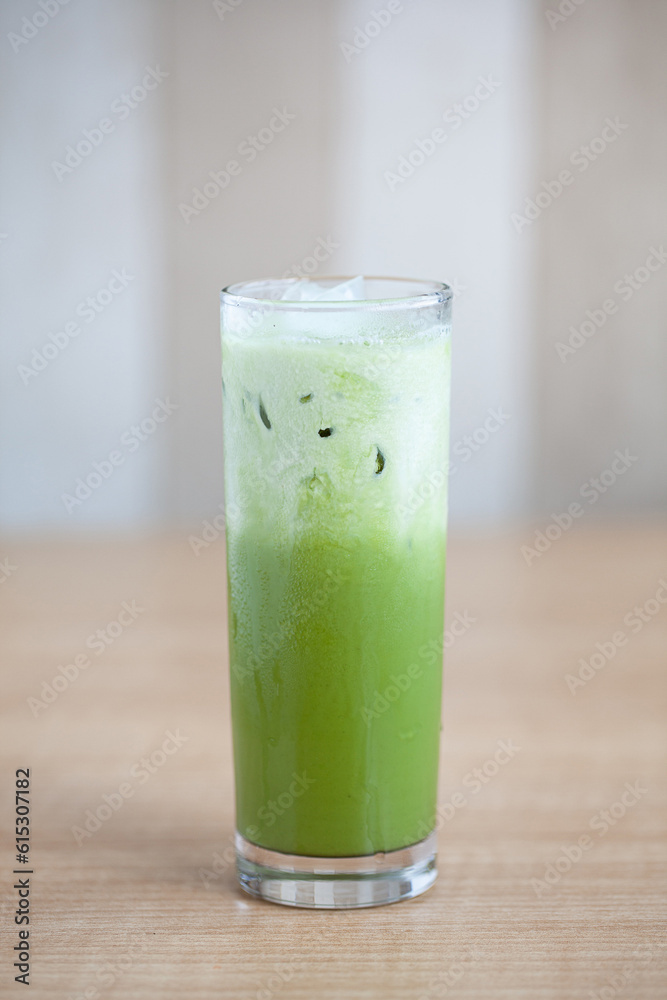Green tea Matcha with milk and ice in round glass isolated on white with shadow and light. Cold drink famous for detox and healthy beverage in Japan and Korea and Asia melting under sun hot weather. Green tea Matcha with milk and ice in round glass isolated on white with shadow and light. Cold drink famous for detox and healthy beverage in Japan and Korea and Asia melting under sun hot weather.